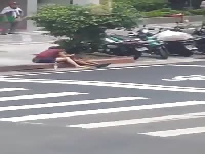 Chinese prostitute giving hand job for client in middle of street 
