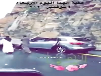 Huge rock falls directly on a passing car killing its two passengers instantly.  