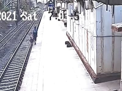 Boy who fell from a platform onto rail tracks rescued (different angle).