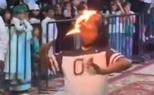 A person who displays oil with fire