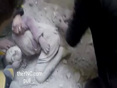 The body of a girl was rescued from the rubble after the aerial bombardment of the city of Hammouriyeh