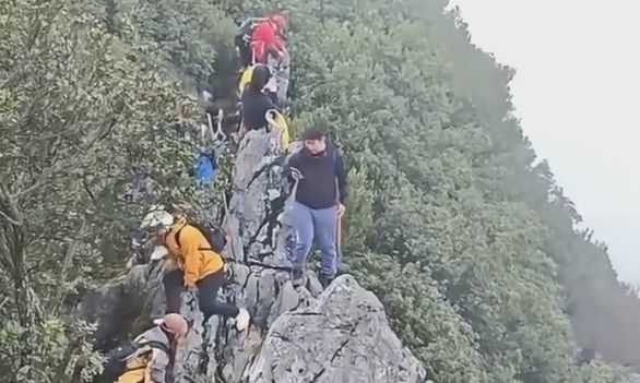 Man DIstracted By Phone Falls Off Cliff In China