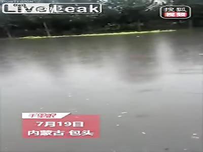 Old man nearly drowns in a flooded street
