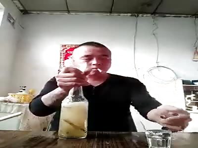 Man swallows fish from a bottle.