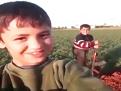 Iraqi boy shooting an AK47.