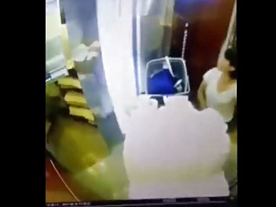 Hotel  lift fails just as a cleaning lady is exiting