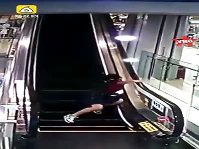 woman gets her hand stuck in the escalator