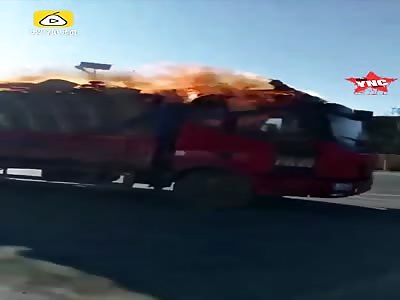 man drives a truck while on fire in Donggang