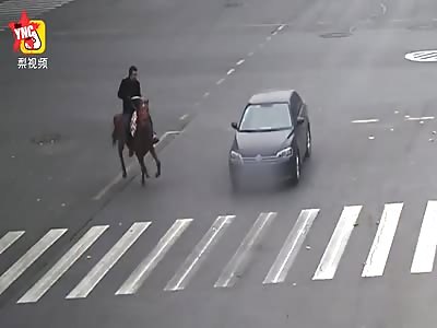 a man riding fast  on a horse on a china road is not a good idea 