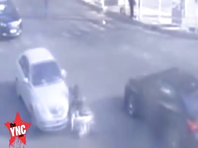a girl gets hit twice on her bike on Yanhe Road
