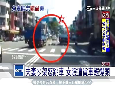 man thrown his wife out of a car and she was inches away from getting her head crushed in Taoyuan