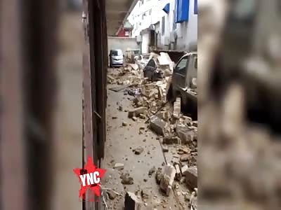 several cars destroyed when a wall  collapsed near the Pengyu Hospital in Haifeng County 