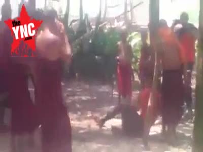 Buddhists beat thief outside the  holy Monastery