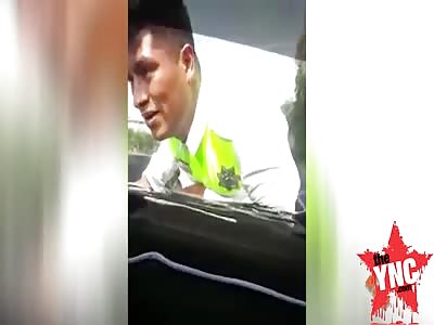 in Mexico man drives fast while  policeman is stuck on the top of his Car Bonnet