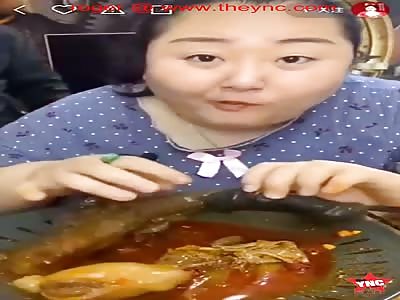 a disgusting fat chinese woman eats a cooked large animal penis  and its balls