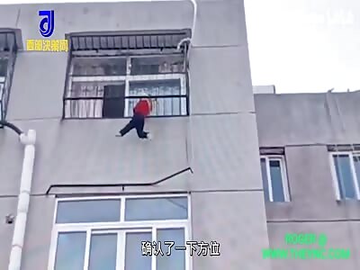 2-year-old girl hanging on the 6th floor window gaurd rail in Nanyang 