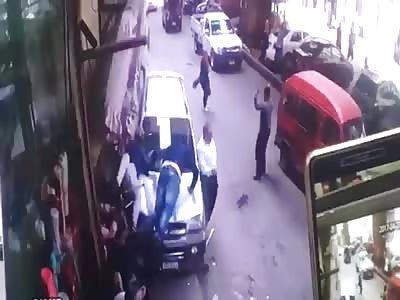 Two People Sitting the Side of the Street Run Over by a Car