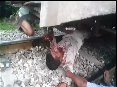 Man Agonizing under Train With Legs Torn Apart