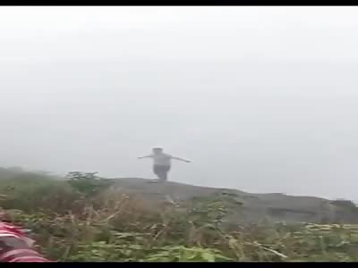 Woman On Cliff Edge Leans Back to Her Death (Angle 2)