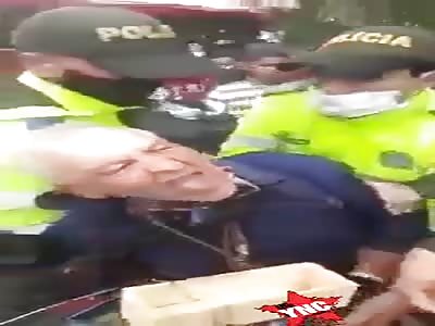 Old man beaten and arrested by Colombian police, just for  work