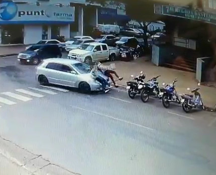 Old woman in car runs over two young women
