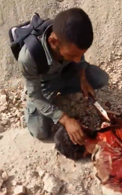 Iraqi soldier mutilating DAESH corpse