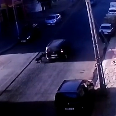 Car in reverse knocks and kills an old woman