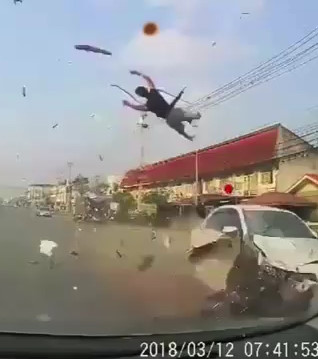 Motorcyclist hit by car and goes flying.