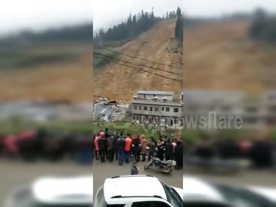 Three houses buried and four killed in massive Chinese landslide