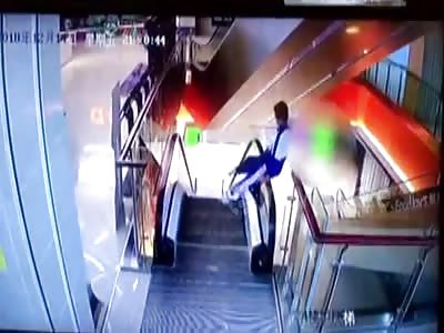 Naughty student climbs onto escalator handrail and falls one storey