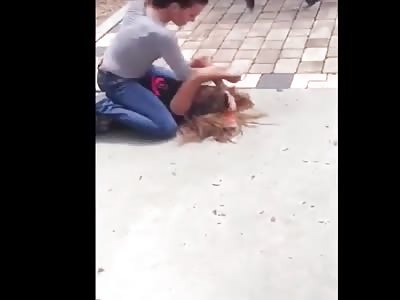 Girl fight ends with head bashing.