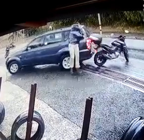 Car Fish Tails into Biker Stopped on Road