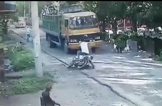 Biker Loses Control, Crushed by Truck
