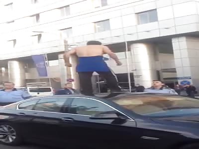 Serbian crack head jerks off on top of a car.