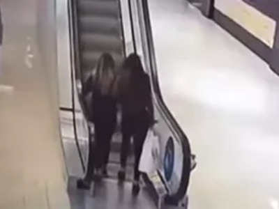 Two Girls vs. Escalator.