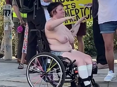 Topless Chesty Chubby Disabled Protestor fakes Wheelchair