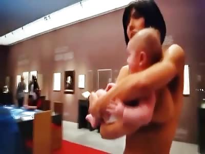 Live Art?  Naked Woman Walks Around Museum with a Baby in her Arms