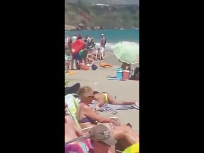 Topless Woman in Yellow Bikini on a Beach Secretly Tries to Fingers Herself While 100's of People are Around