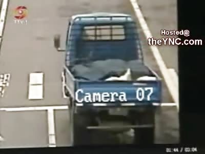 CRAZY: Insane Chinese Man Attempts Suicide by Laying under Trucks Tires at a Red Light