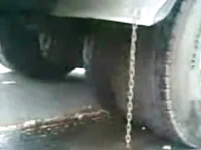 Headless Female in Contorted Position after being Trampled to Death by Truck