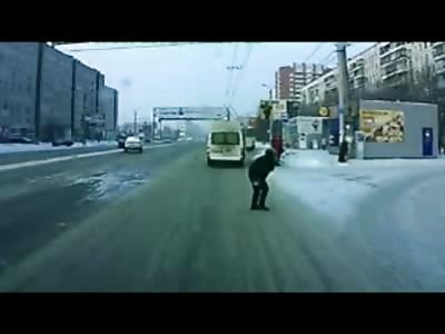 Idiot gracefully hit by a Bus