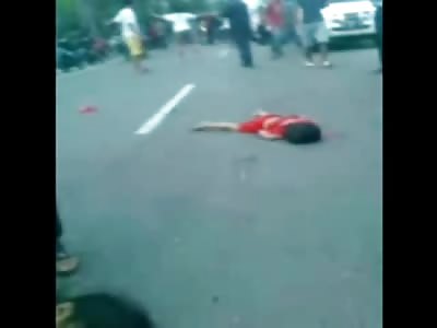 Squirming Mother Dying on the Street next to her already Deceased Children 