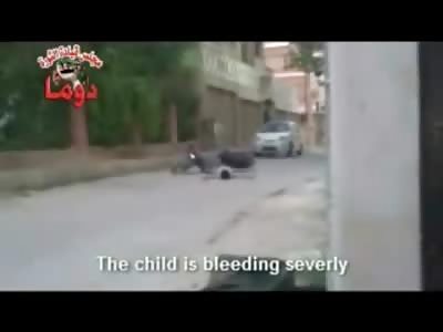 Boy hit by Sniper Fire Begging for Help on the Street as Snipers still Try to Kill hIm