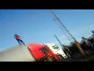 Deranged Woman Dances on Top of a Semi-Truck before Jumping off 