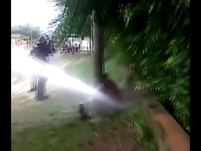 Soldiers handcuff Man to a Pole and Blast him with Water Cannon