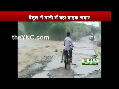 Man Riding his Bike During a Flood is Washed away in a River