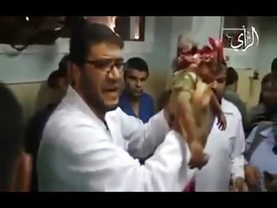 Doctor makes Statement holding Up Baby with Head Exploded in Front of Cameras in Gaza