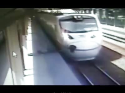 Brutal Suicide..Man Jumps into Path of Speeding Train and is Thrown Against Pole