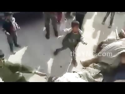 Little Kids Get in the Jihad Action Start Beating Dead Bodies with Sticks