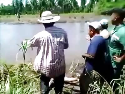 Villagers Pry a Dead Man from the Jaws of a Crocodile 